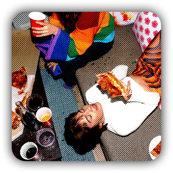 Overhead view of a person lying on the floor surrounded by colorful art supplies and food items