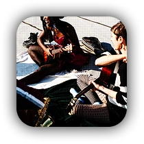 Musicians performing together, photographed from a dynamic angle showing guitars and instruments